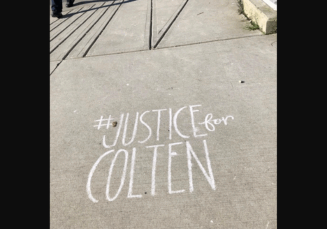 #JUSTICEforCOLTEN written in chalk on sidewalk.