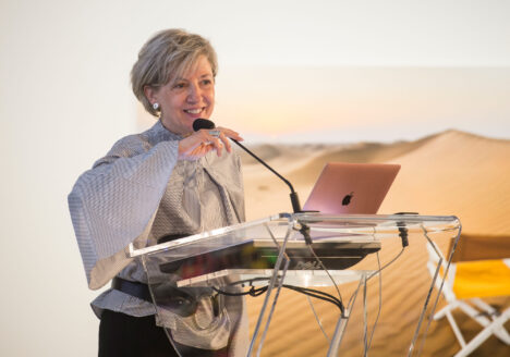 Shari Graydon speaks into microphone at podium
