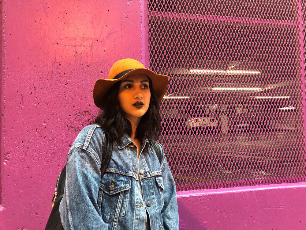 Anya Zoledziowski pictured in front of pink wall