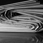 Folded newspapers in black and white