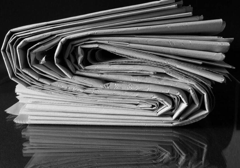 Folded newspapers in black and white