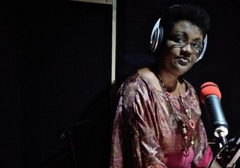 Reporter Josine Kaze records a news broadcast in the Inzamba studio, which was built in the converted living room of a private home