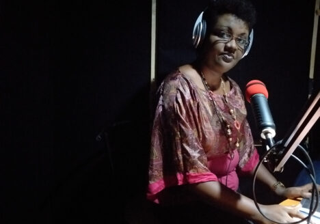 Reporter Josine Kaze records a news broadcast in the Inzamba studio, which was built in the converted living room of a private home