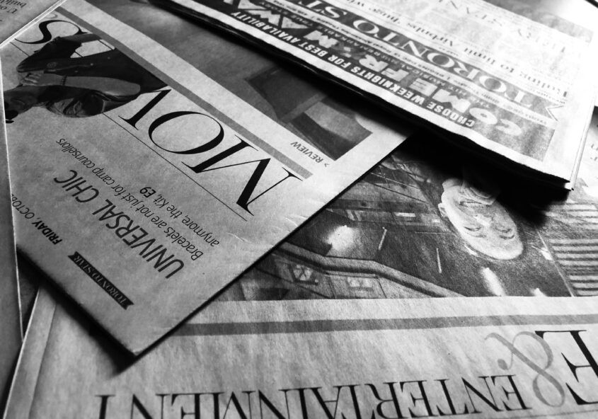 Toronto Star newspaper sections laid out overlapped, in black and white