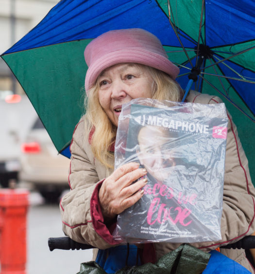 Joan M. sells copies of Megaphone Magazine in Downtown Vancouver in 2018