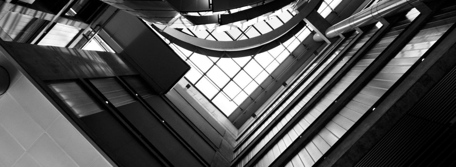 The interior of the Bahen Centre for Information Technology in black and white.
