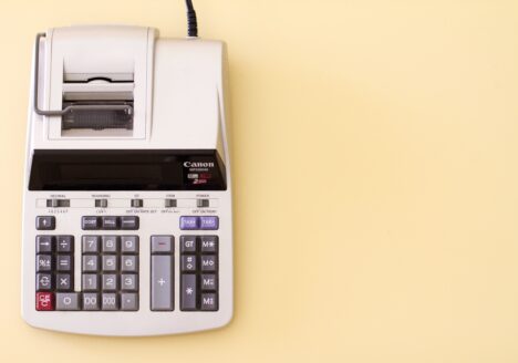 Ten-key accounting calculator on yellow desk scaled.