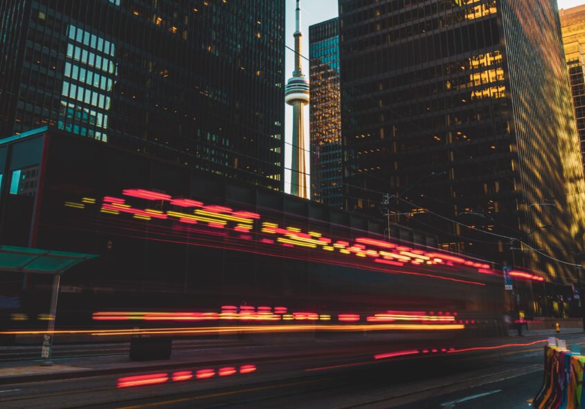 CN Tower at Sunset with light trails from a Fire Truck whizzing by.