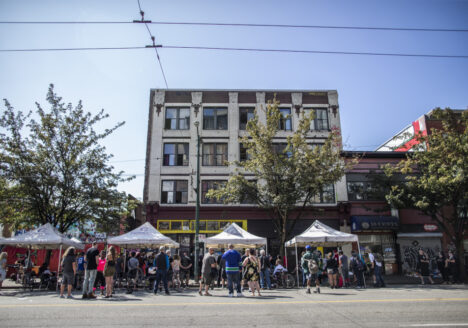 People gather on East Hastings Street to remember Thomus Donaghy, an overdose prevention worker who was stabbed to death on July 27, 2020, while he was on duty.