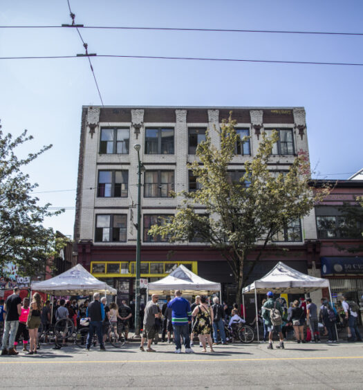People gather on East Hastings Street to remember Thomus Donaghy, an overdose prevention worker who was stabbed to death on July 27, 2020, while he was on duty.