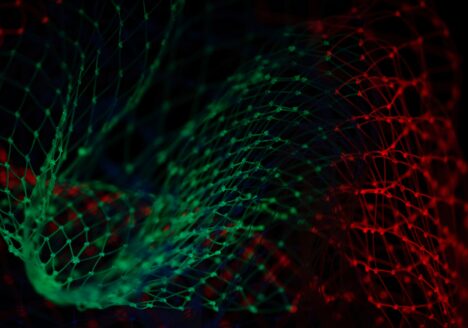 Green, red and blue light reflecting off netting over black background.