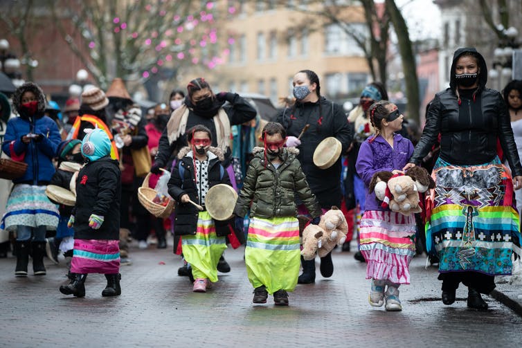 Young girls walk together during the annual Women’s Memorial March in Vancouver in February 2021. The march is held to honour missing and murdered Indigenous women and girls with stops along the way to commemorate where women were last seen or found. THE CANADIAN PRESS/Darryl Dyck