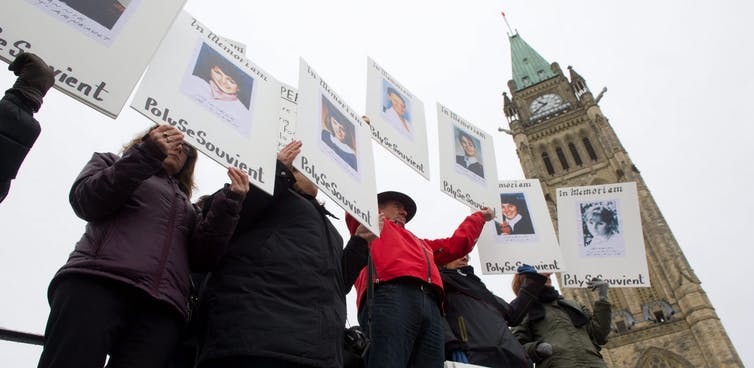 People take part in a memorial rally during the National Day of Remembrance and Action on Violence against Women in Canada on Parliament Hill. THE CANADIAN PRESS/Sean Kilpatrick