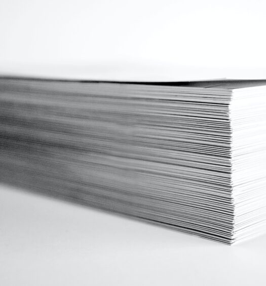 Stack of white paper on white background.