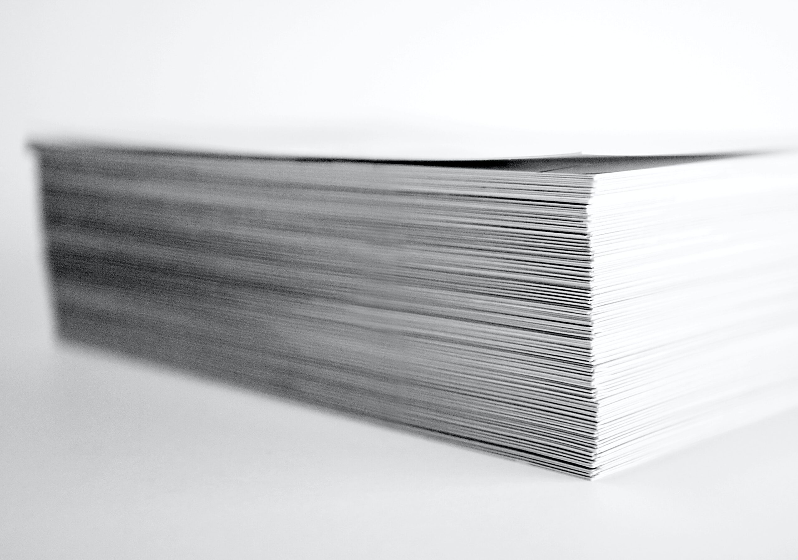 Stack of white paper on white background.