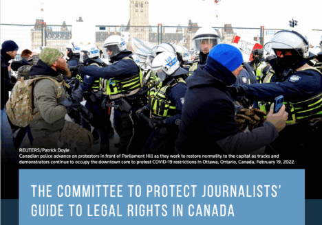 Canadian police advance on protestors in front of Parliament Hill. Text overstop image reads: REUTERS/Patrick Doyle Canadian police advance on protestors in front of Parliament Hill as they work to restore normality to the capital as trucks and demonstrators continue to occupy the downtown core to protest COVID-19 restrictions in Ottawa, Ontario, Canada, February 19, 2022 The Committee to Protect Journalists’ Guide to Legal Rights in Canada