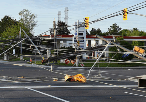 Powerlines lie across the road and trap a vehicle after a derecho passed through Ottawa in May 2022.