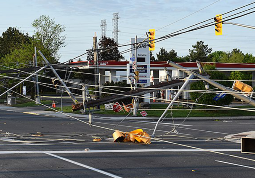 Powerlines lie across the road and trap a vehicle after a derecho passed through Ottawa in May 2022.