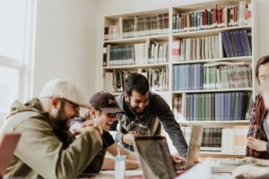 A group of students work in the library on a project