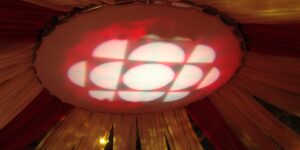 CBC red and white logo projected on ceiling surrounded by draperies.